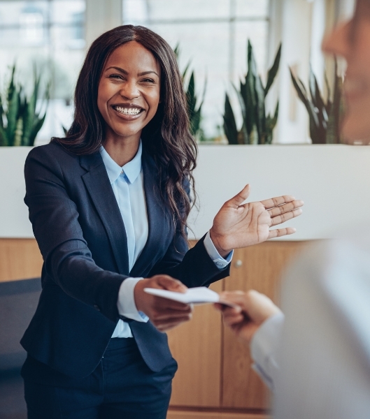 A professional benefit consultant smiling in a modern office