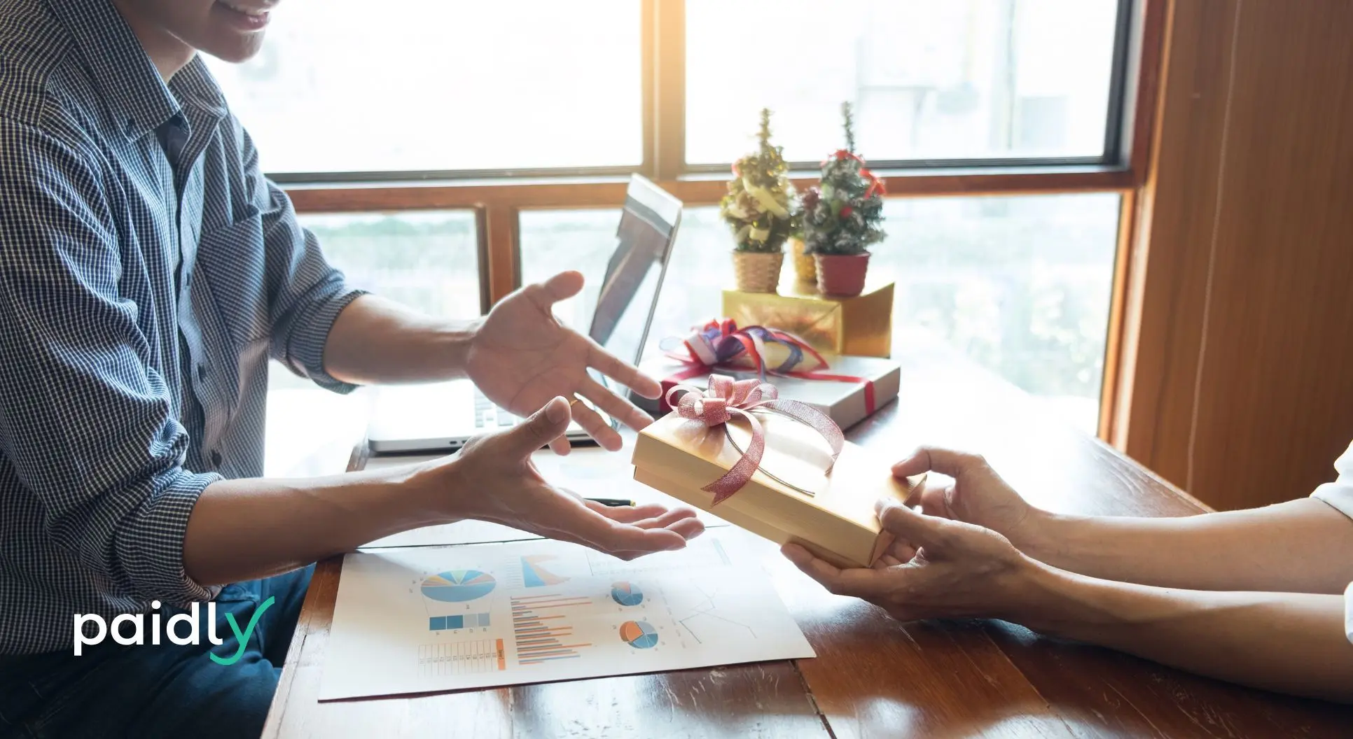 Maximize Employee holiday bonuses person handing someone else a holiday gift