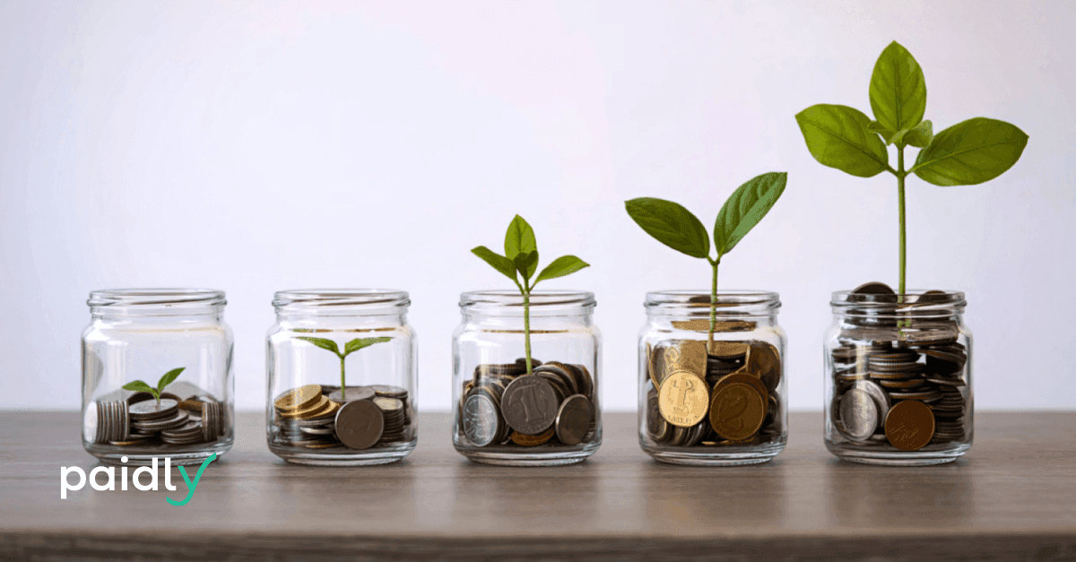 Breaking the Cycle: How Modern Benefits Can Support Generational Wealth Building Jars of coins with plants growing out of them with Paidly logo